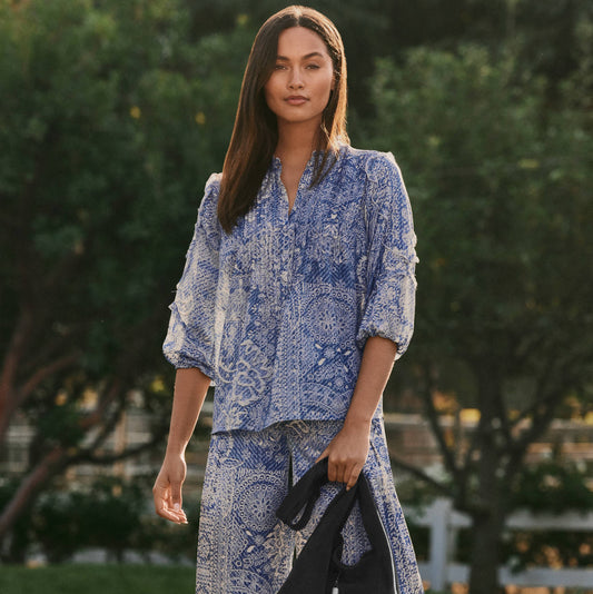 Woman in blue patterned top and pants