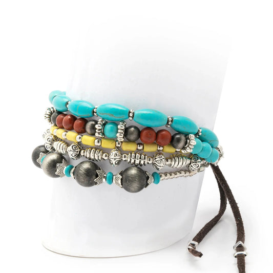 Stacked turquoise beaded bracelets on white display