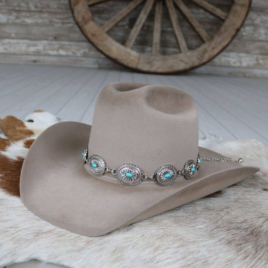 Cowboy hat with turquoise and silver embellishments.
