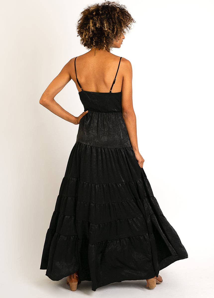 Woman in a black maxi dress, back view.