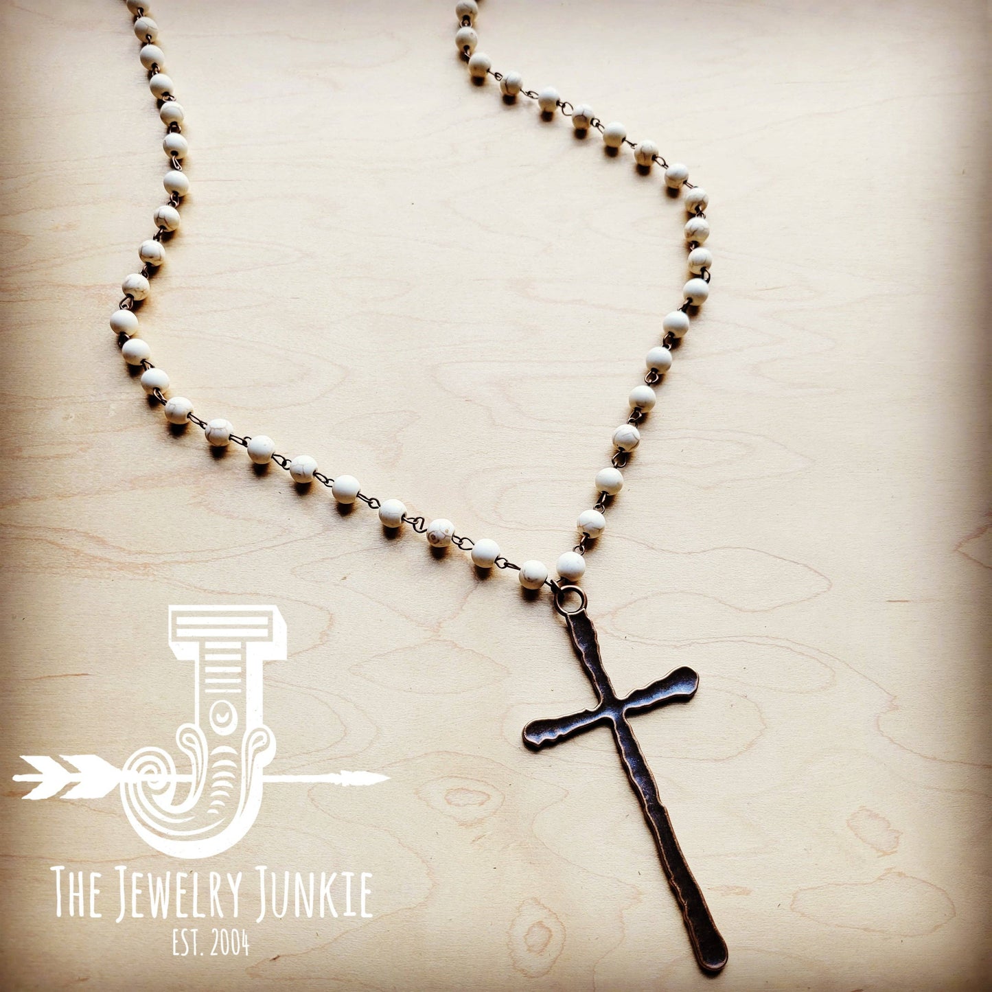 Beaded necklace with a cross pendant.