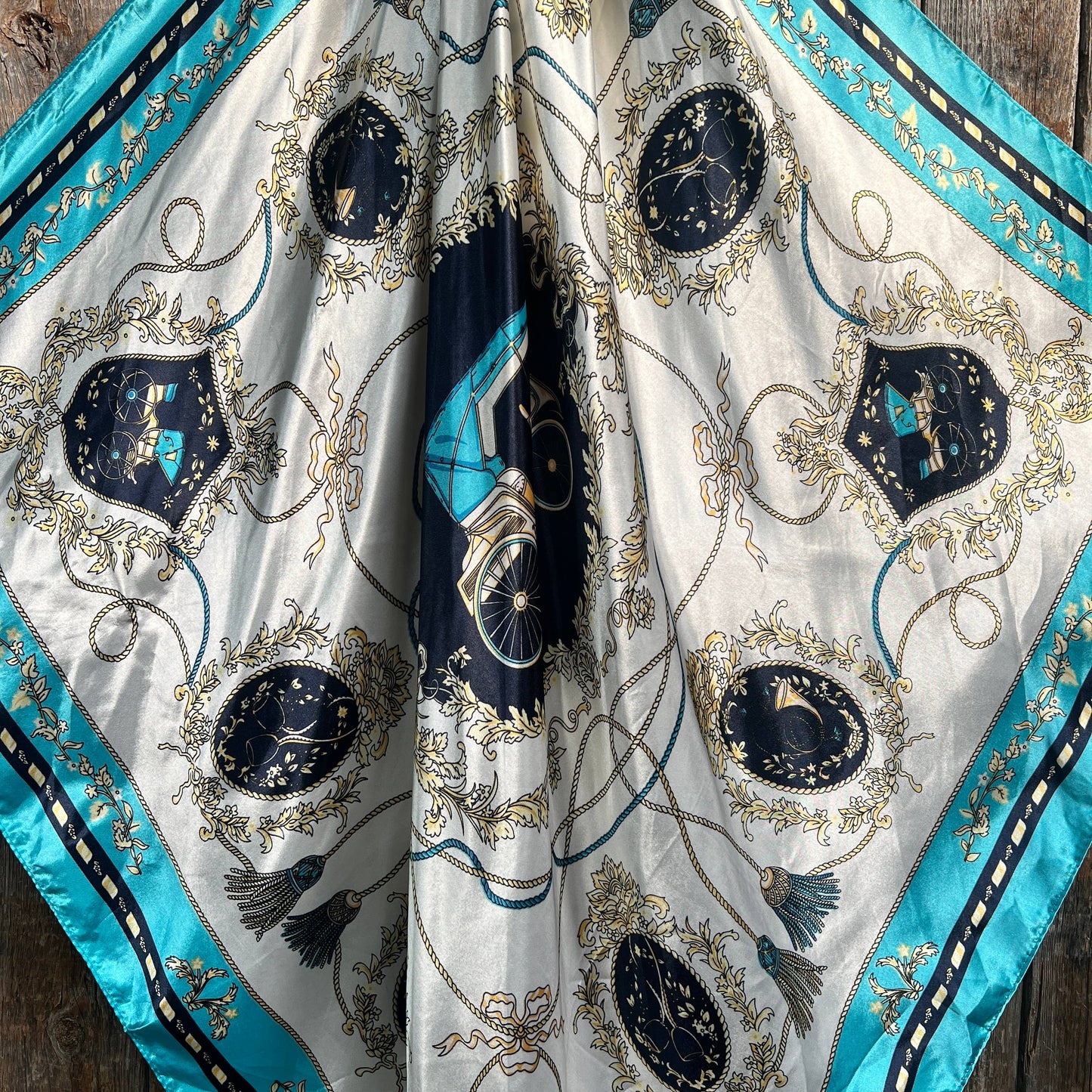 Silk scarf with ornate design.