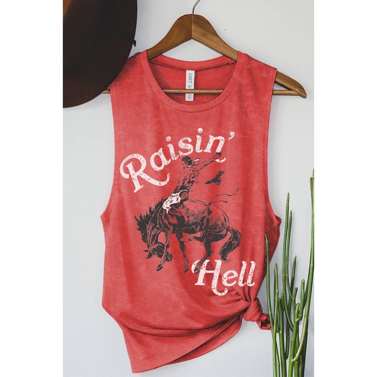 Red tank top with Raisin' Hell graphic and a cowboy.