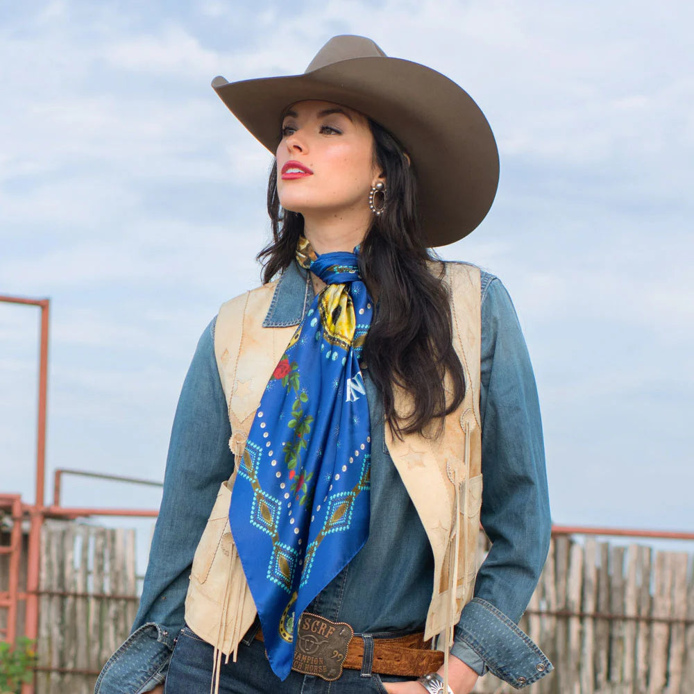 Cowgirl in royal blue vintage horse scarf and hat.