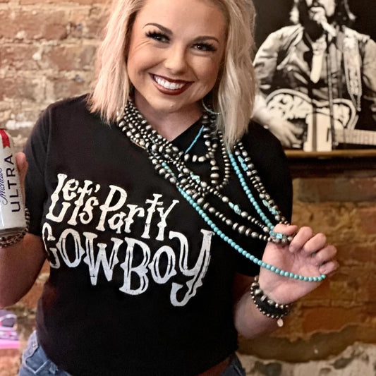 Woman in Let's Party Cowboy shirt holding beer and jewelry