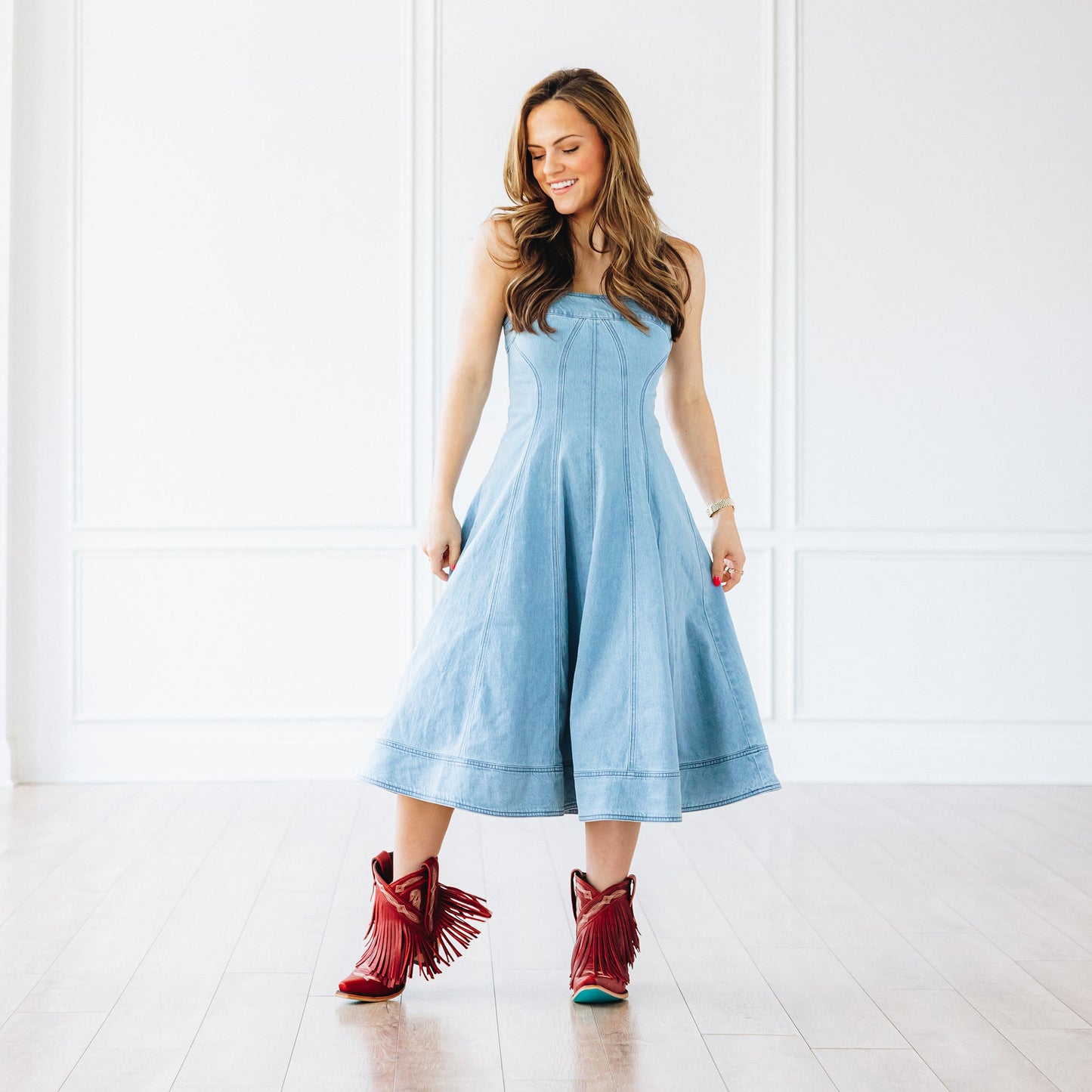 Woman in blue dress and red Senita Falls bootie