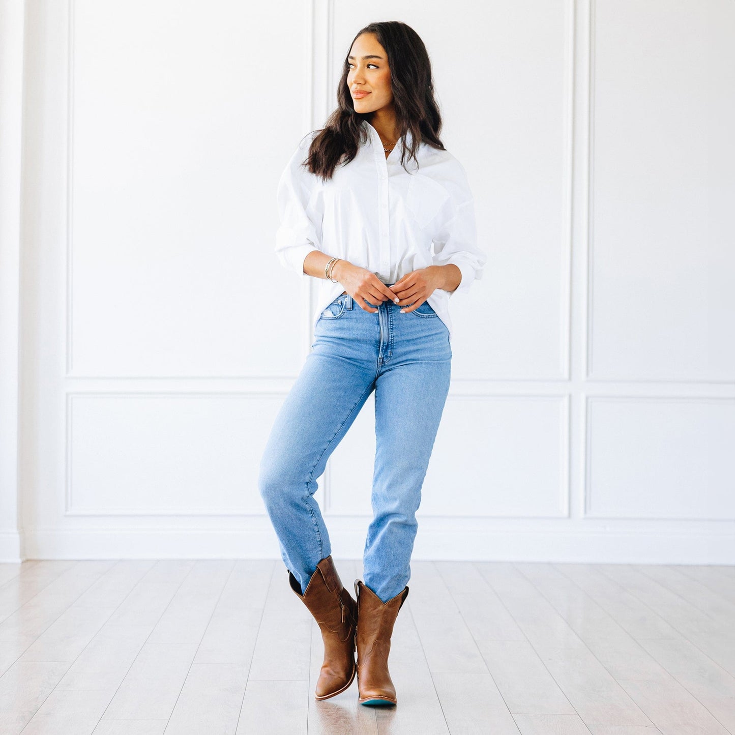 Woman in jeans and desert clay cowboy boots