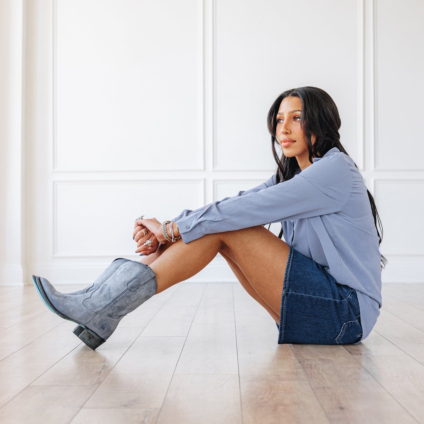Woman in washed denim midi with grey cowboy boots