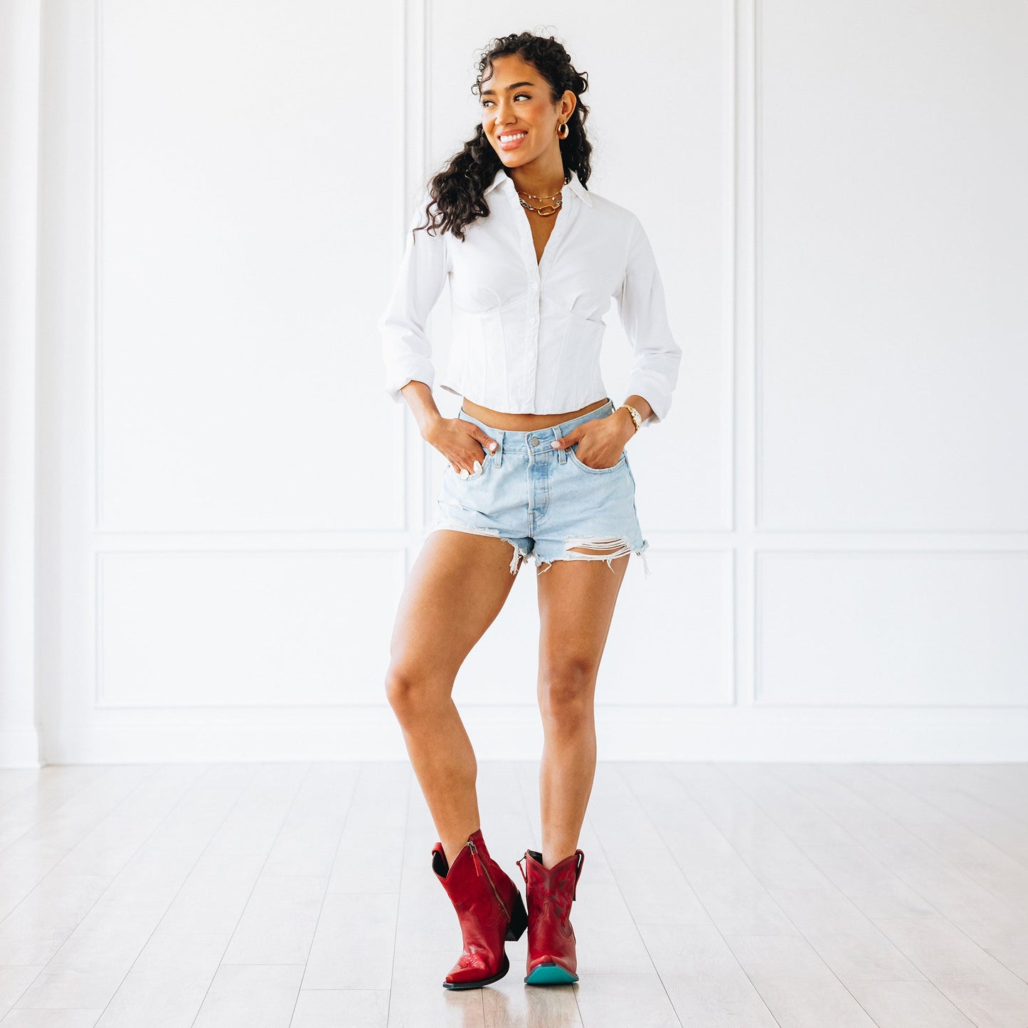 Woman in ruby boots and denim shorts