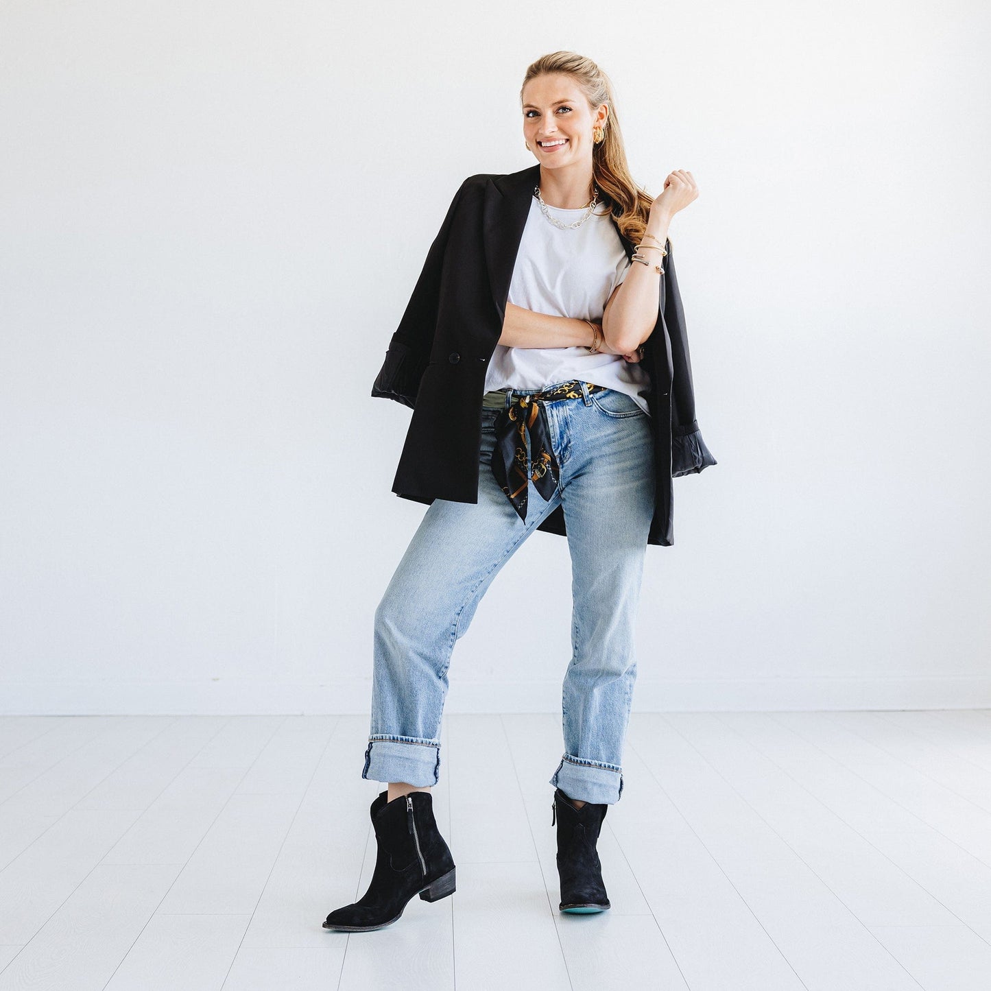 Woman in black suede booties and casual outfit