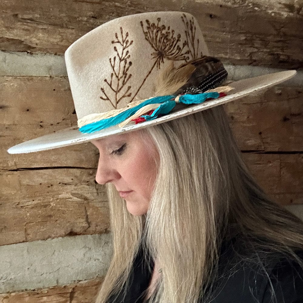 Tan hat with floral embroidery on woman