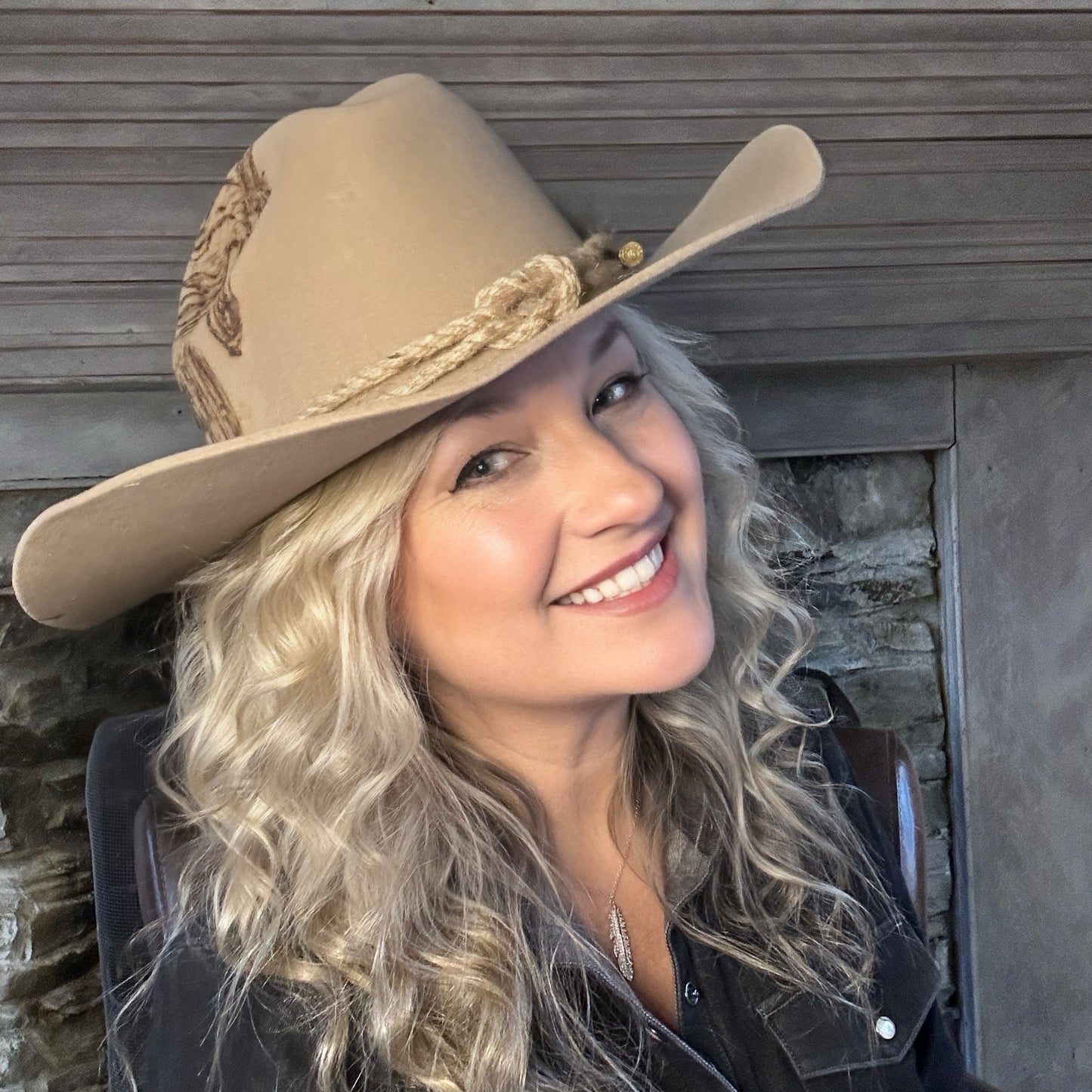Woman wearing tan cowboy hat
