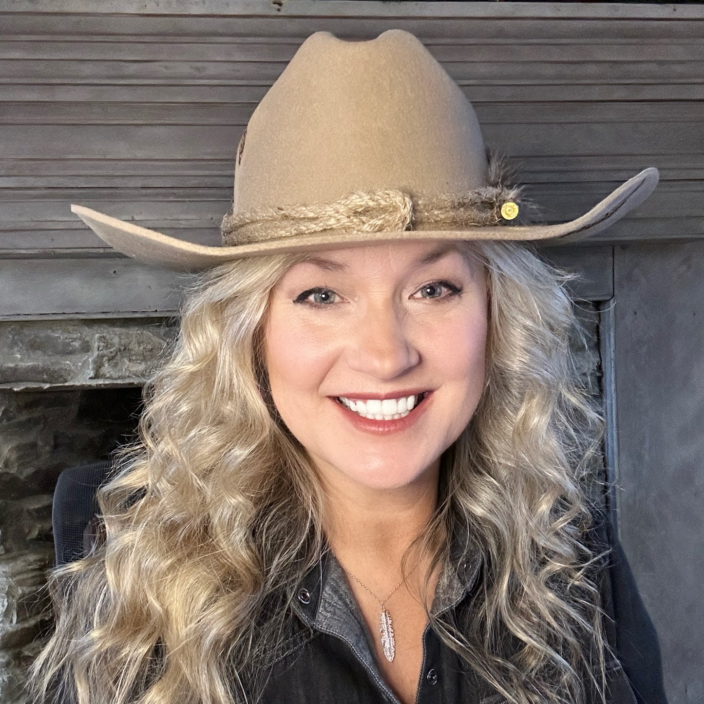 Woman wearing a tan cowboy hat smiling