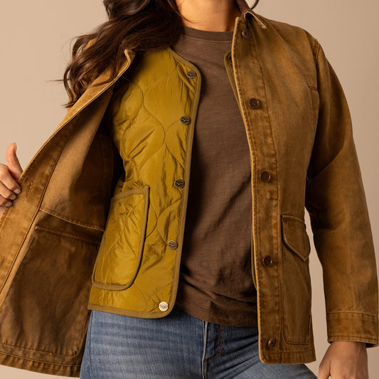 Woman in layered brown and olive jackets