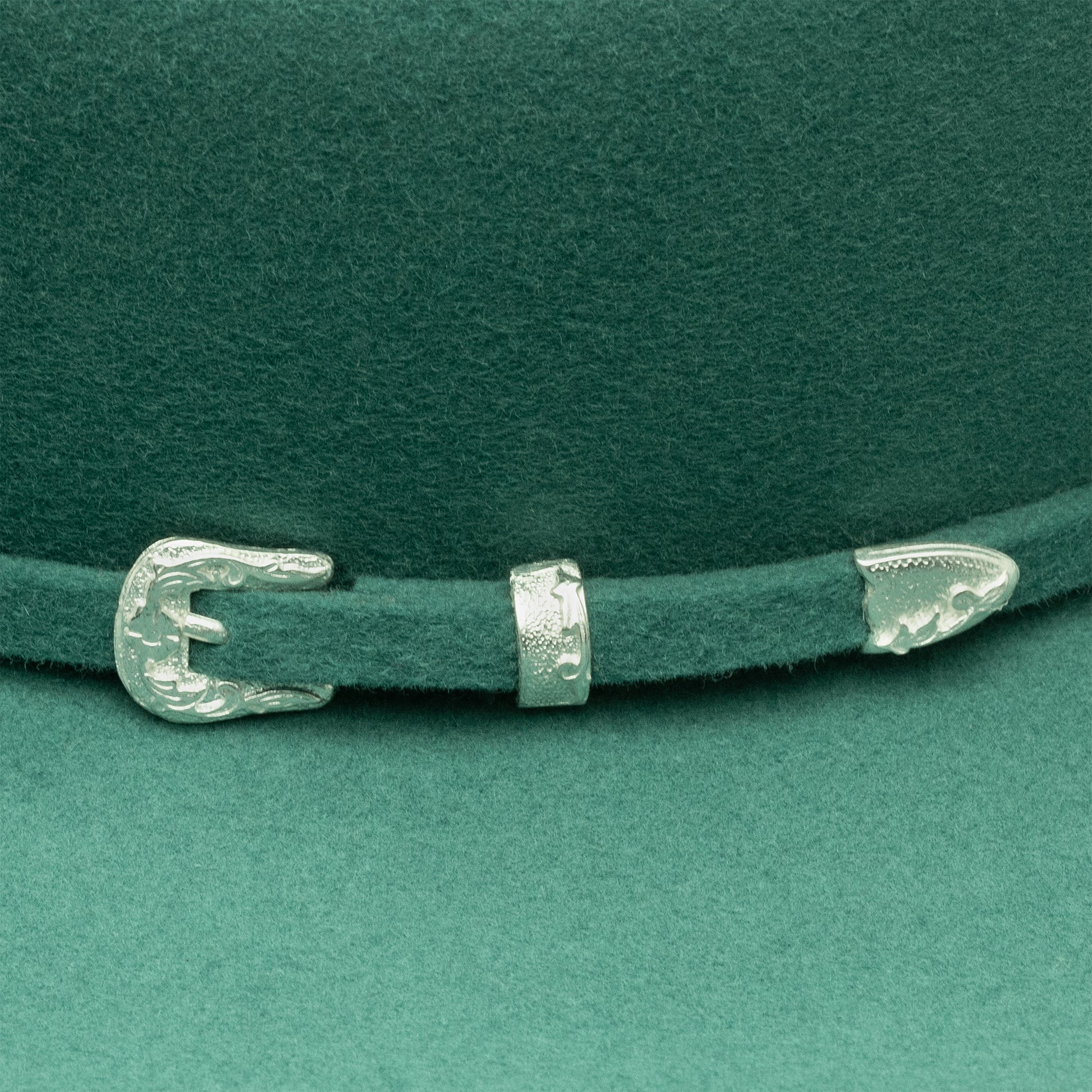 Green cowboy hat detail with silver buckle