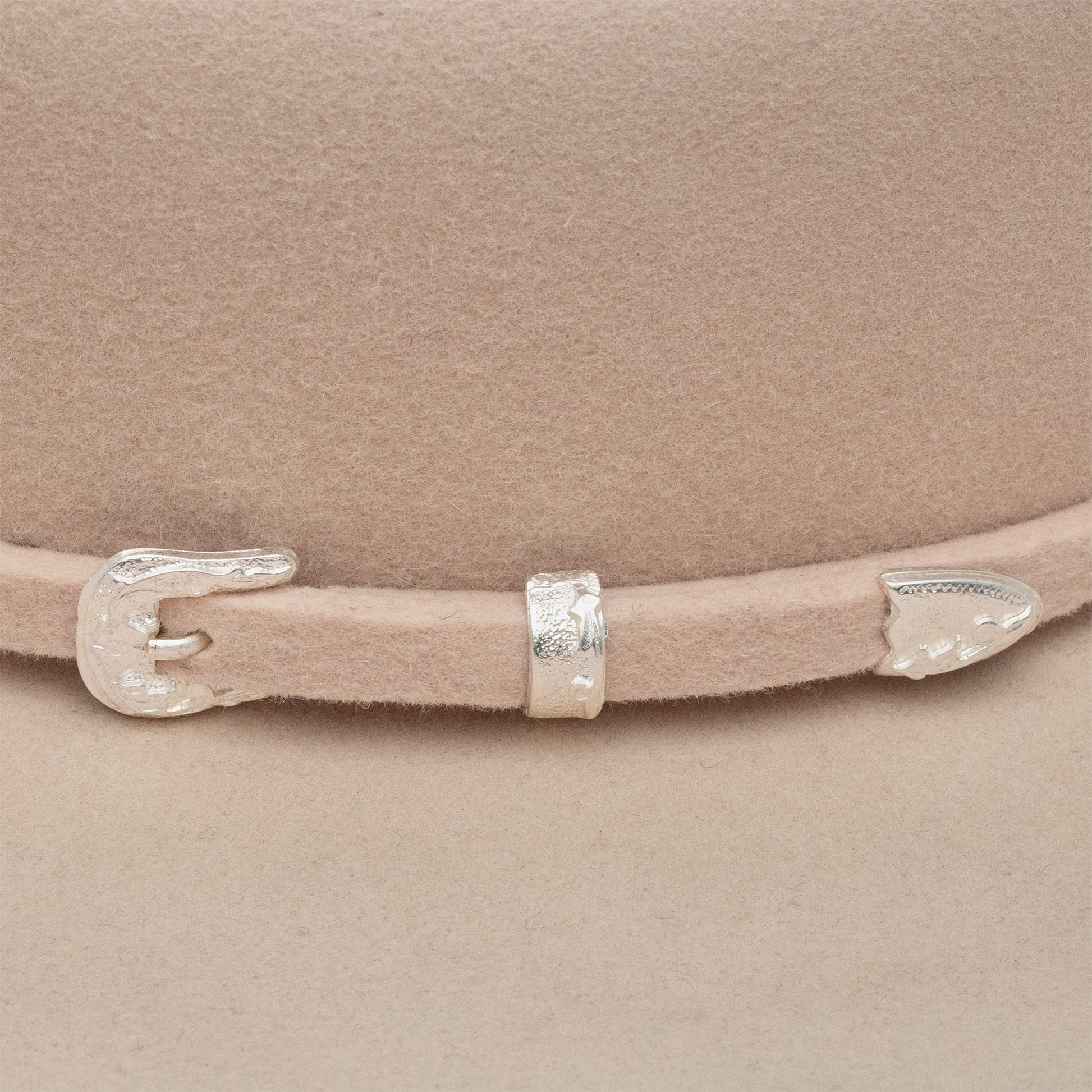 Beige hat with silver buckle detail