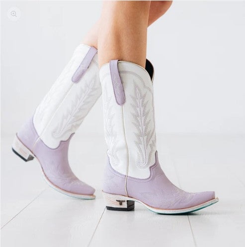 closeup of a woman wearing the best cowboy boots with a lavender color