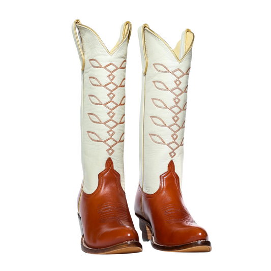 White and brown cowboy boots with decorative stitching
