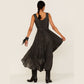 Woman in dark dress and boots, back view.