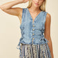 Woman in denim vest.