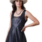 Black leather Spur To Valor dress with woman in hat.