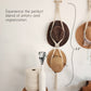 Hats hanging on a macrame wall organizer.