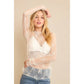Woman wearing white lace top and jeans.