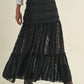 Woman wearing black lace skirt and boots.