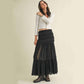 Woman in black maxi skirt and white top