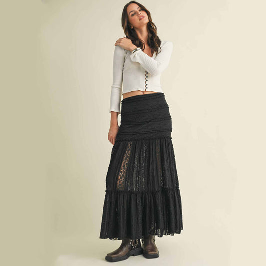 Woman in black maxi skirt and white top