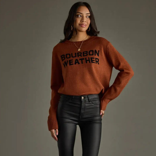 Woman in sweater and black pants.