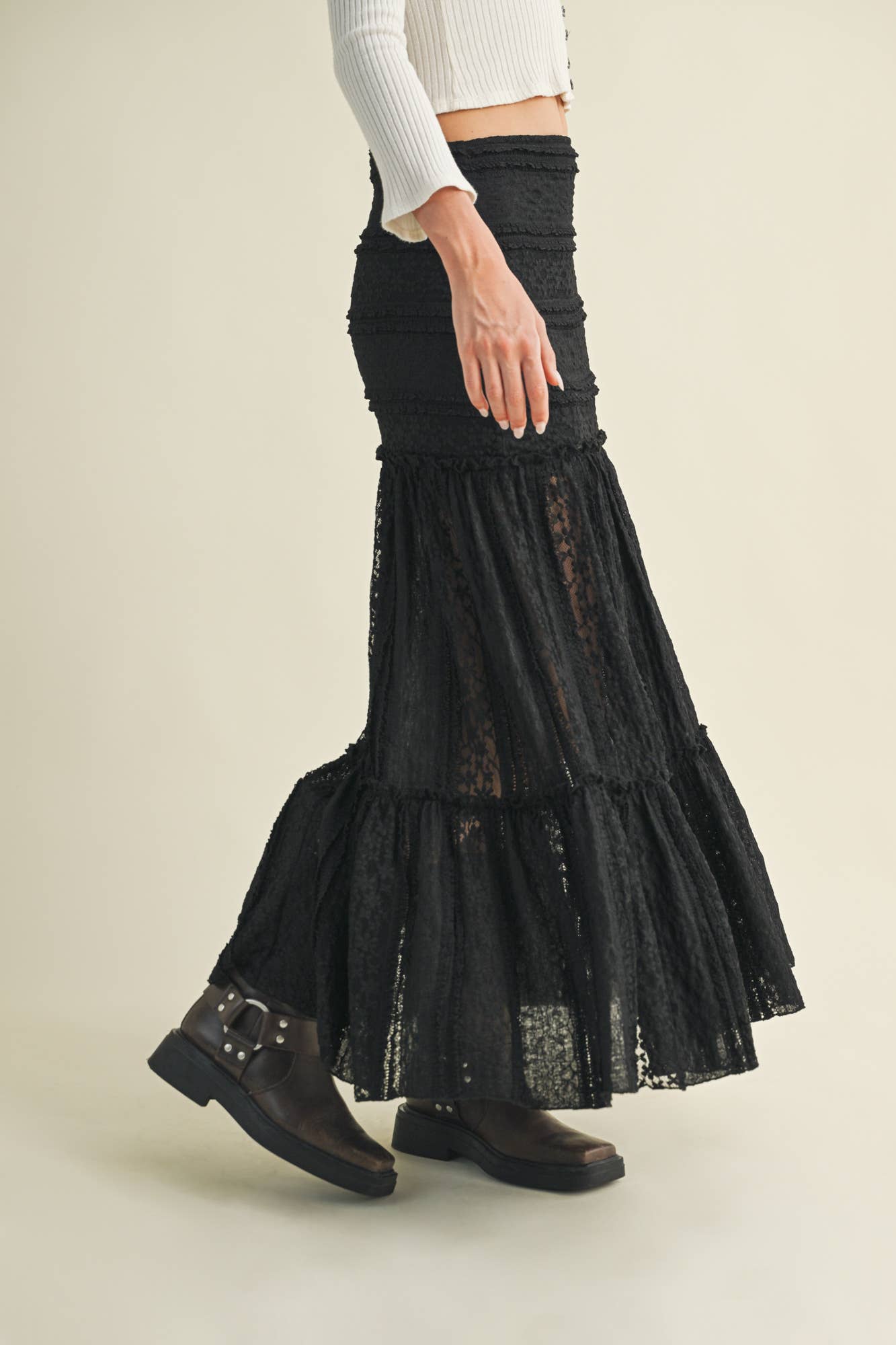 Woman in black skirt and boots.
