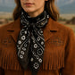 Woman wearing black bandana and brown suede jacket