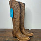 Brown leather cowboy boots with stitching.