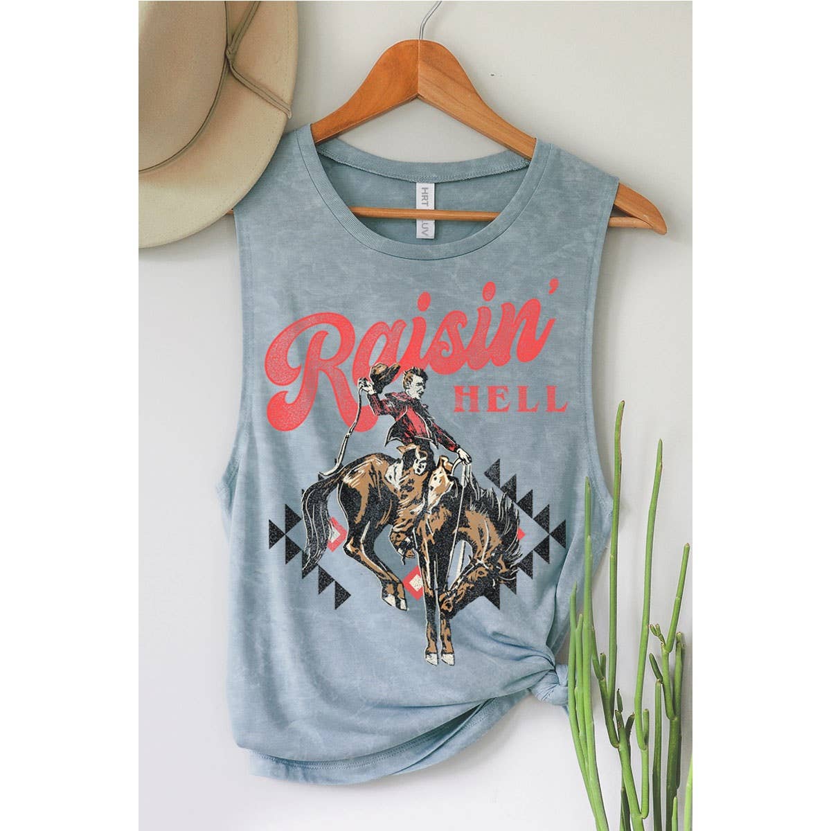 Blue tank top with Raisin' Hell graphic and cowboy image.