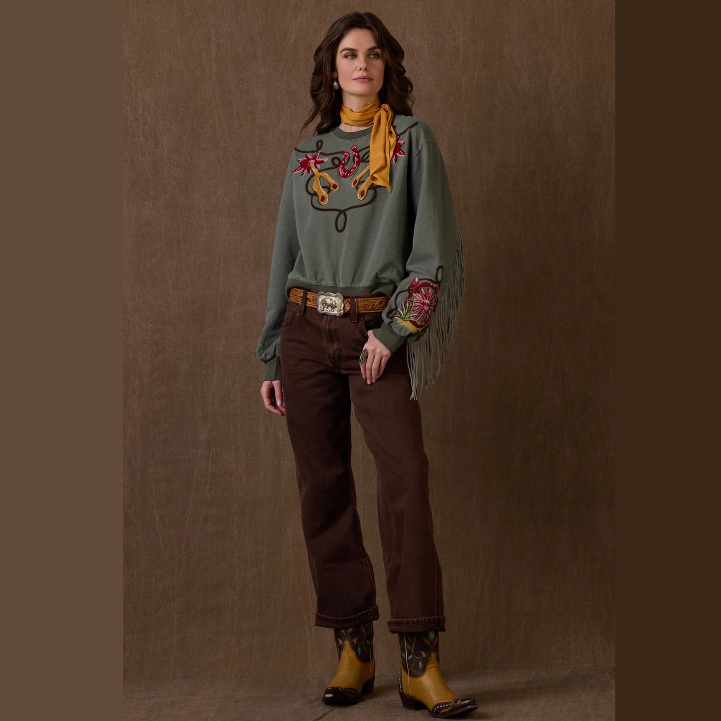 Diggers Sweatshirt with embroidered details, brown pants and boots.