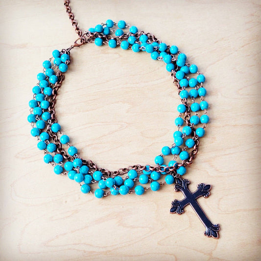 Turquoise beaded necklace with cross pendant.