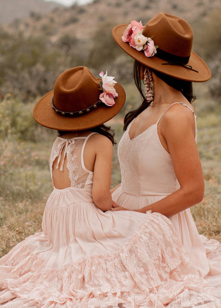 Woman and child in matching hats and dresses.