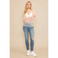 Woman in jeans and sheer top.