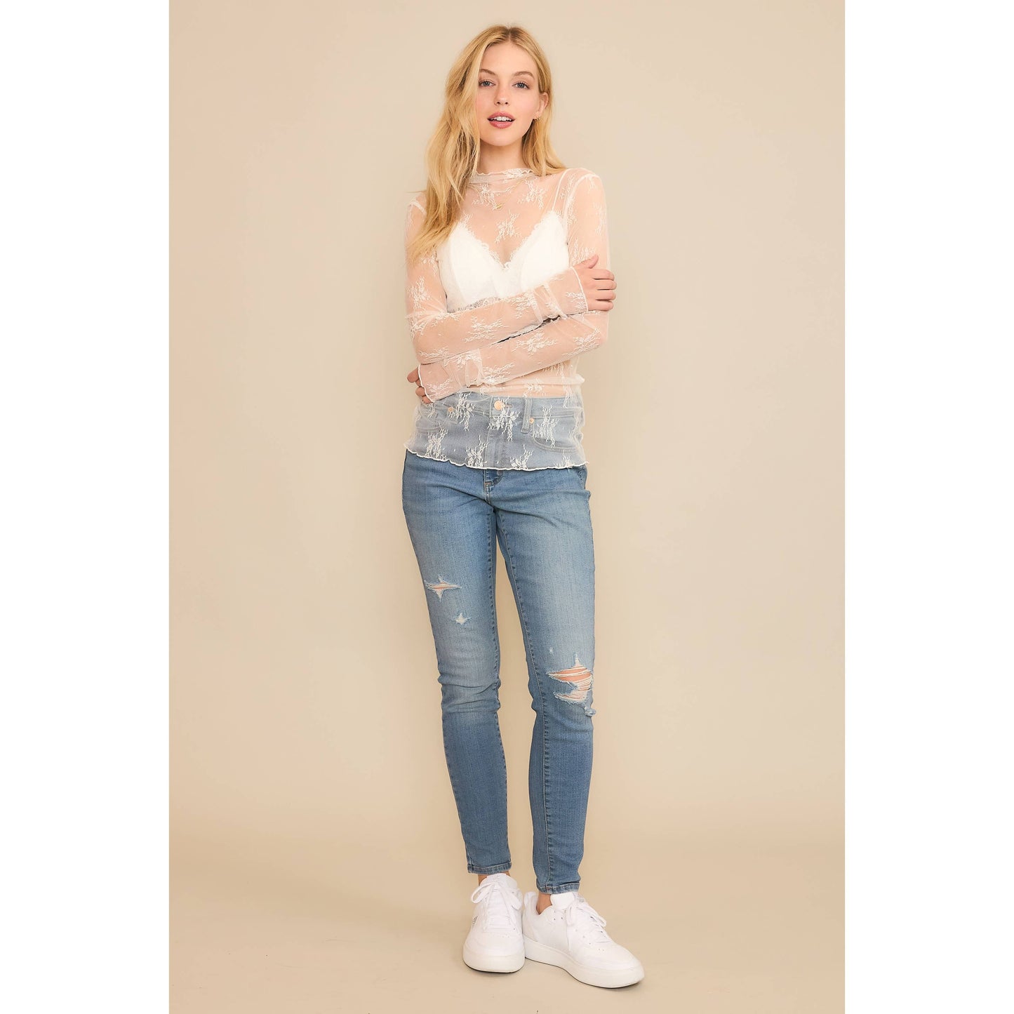 Woman in jeans and sheer top.