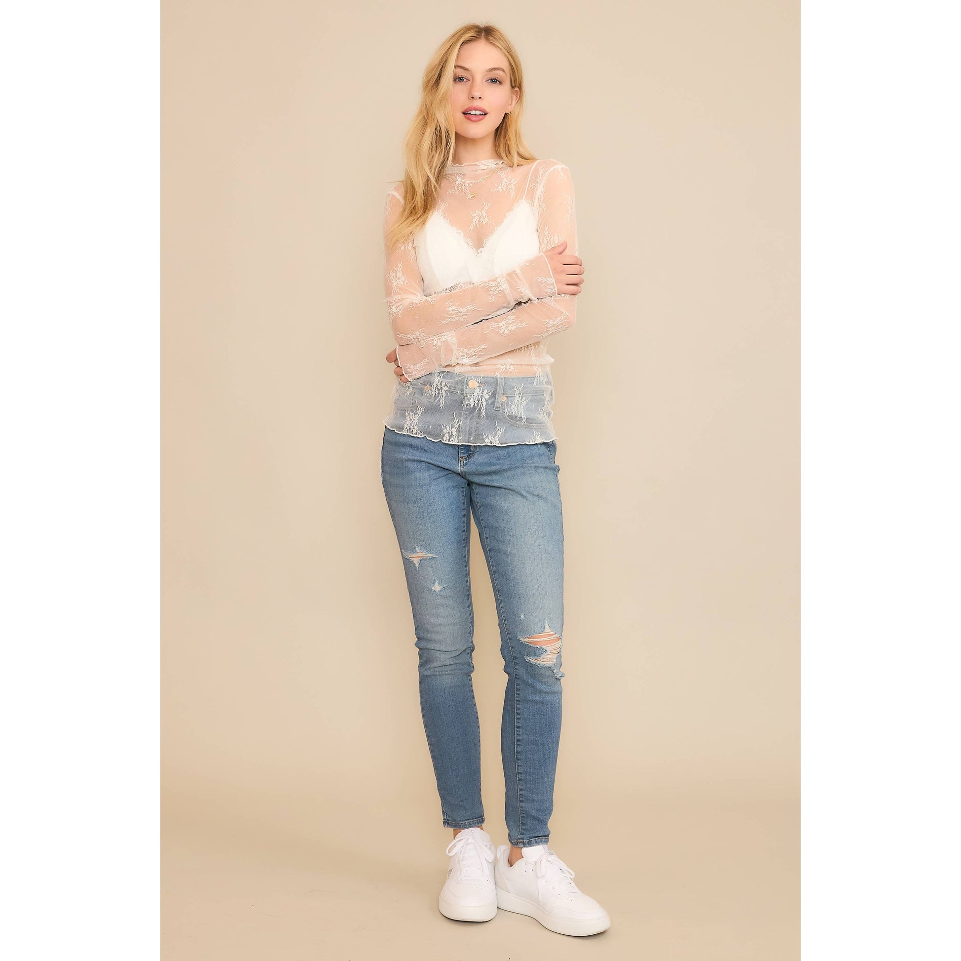 Woman in jeans and sheer top.