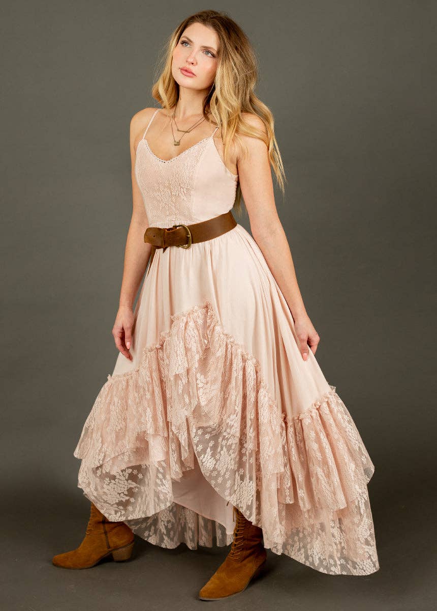 Woman in a pink dress and brown boots.