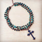 Necklace with turquoise beads and a cross pendant.