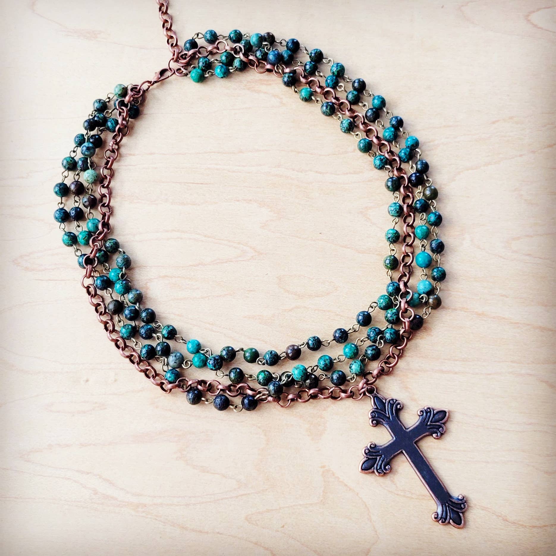 Necklace with turquoise beads and a cross pendant.