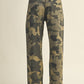 Person wearing camouflage pants and brown sweater.