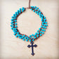 Turquoise beaded necklace with a cross pendant.