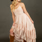 Woman in a pink dress and brown hat and boots.