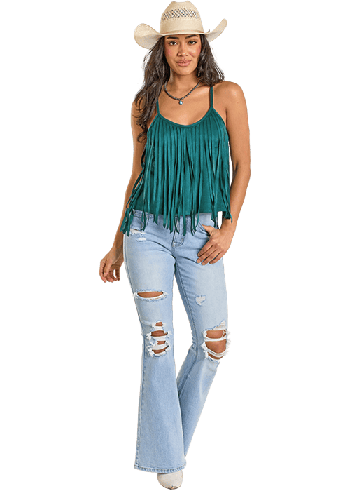 Woman in green fringe top and ripped jeans