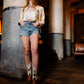 Woman in shorts and cowboy boots leaning against a column (DSC_0321)