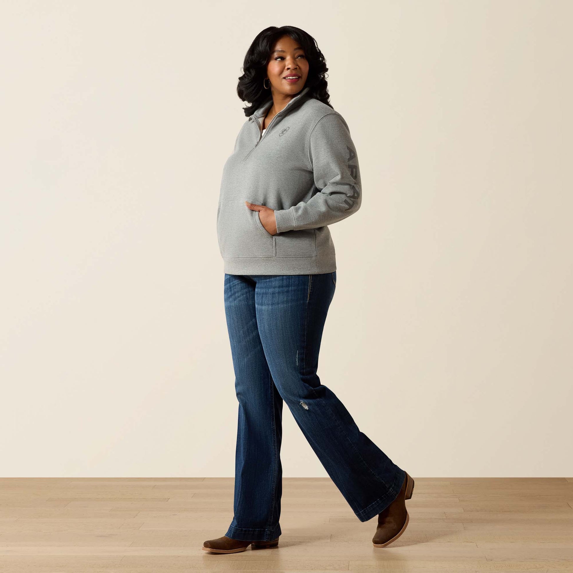 Woman in grey sweatshirt and jeans